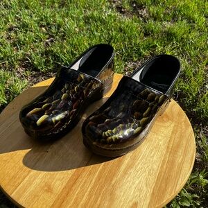 Dansko Glossy Snake-Print Clogs in Black and Olive Green